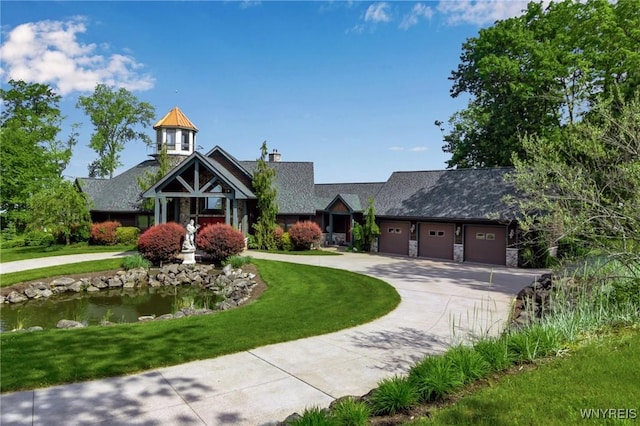 1567 Lake Rd, Porter, NY 14174 - craftsman-style house with curved driveway, a garage, and a front yard