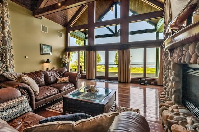 1567 Lake Rd, Porter, NY 14174 - living room with a fireplace, wood-type flooring, high vaulted ceiling, and a wooden ceiling with exposed beams