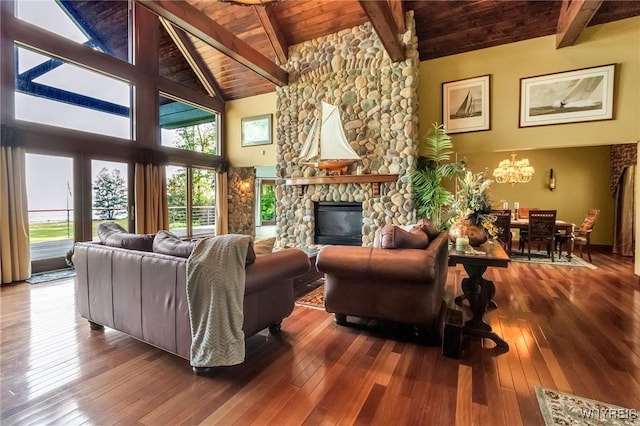 1567 Lake Rd, Porter, NY 14174 - living area featuring a wooden ceiling with exposed beams, hardwood / wood-style floors, a chandelier, a stone fireplace, and high vaulted ceiling