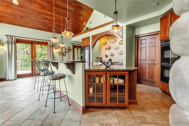 1567 Lake Rd, Porter, NY 14174 - kitchen with lofted ceiling, wooden ceiling, stainless steel fridge with ice dispenser, decorative backsplash, and a kitchen breakfast bar