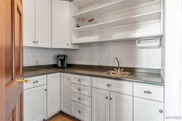 1567 Lake Rd, Porter, NY 14174 - kitchen with open shelves, dark countertops, and white cabinets