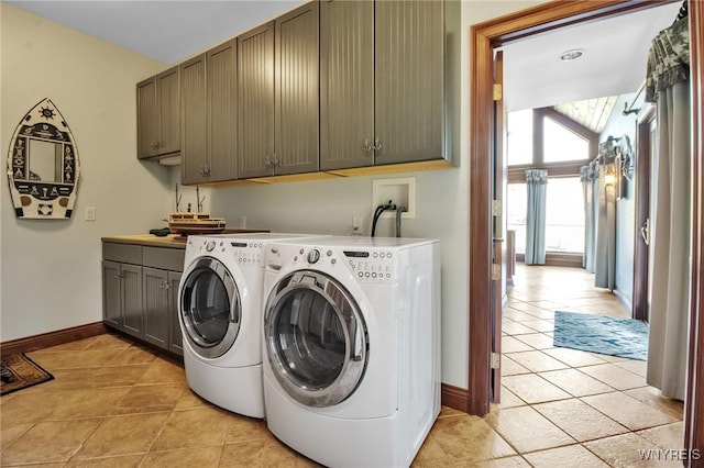1567 Lake Rd, Porter, NY 14174 - washroom with cabinet space, washer and dryer, and light tile patterned floors