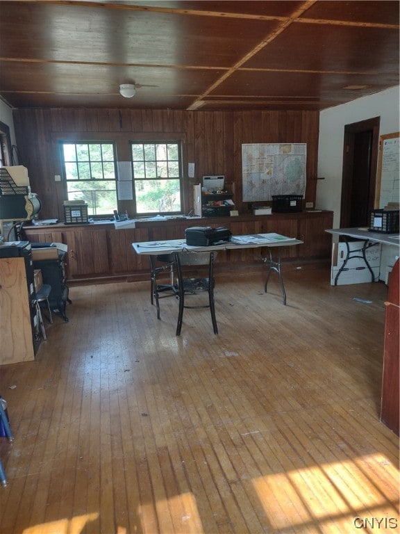 dining area featuring wood walls, light hardwood / wood-style floors, and wood ceiling