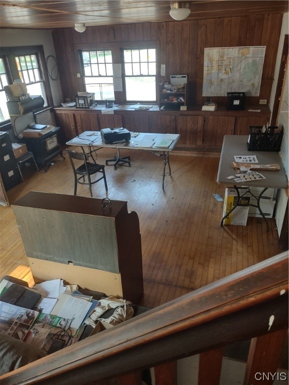 living room featuring wood walls, hardwood / wood-style flooring, and a wealth of natural light