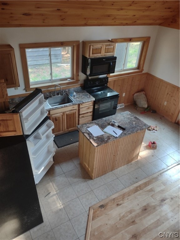 kitchen featuring light tile flooring, sink, black range with electric cooktop, and wooden ceiling