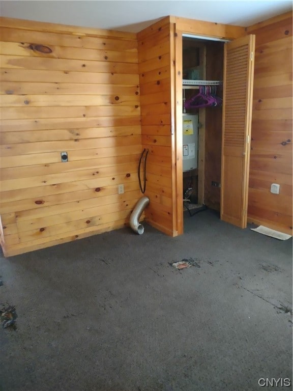 carpeted spare room featuring water heater