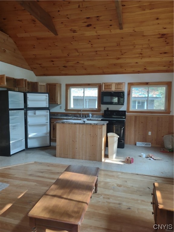 kitchen featuring beamed ceiling, high vaulted ceiling, wood ceiling, light hardwood / wood-style flooring, and stove