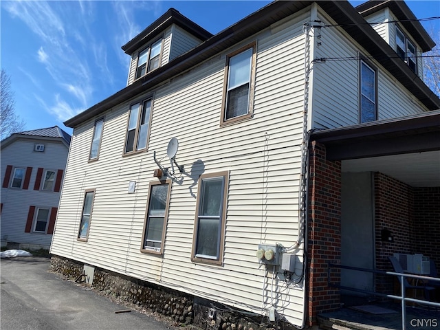 view of property exterior with brick siding