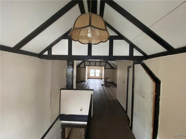 interior space with vaulted ceiling with beams