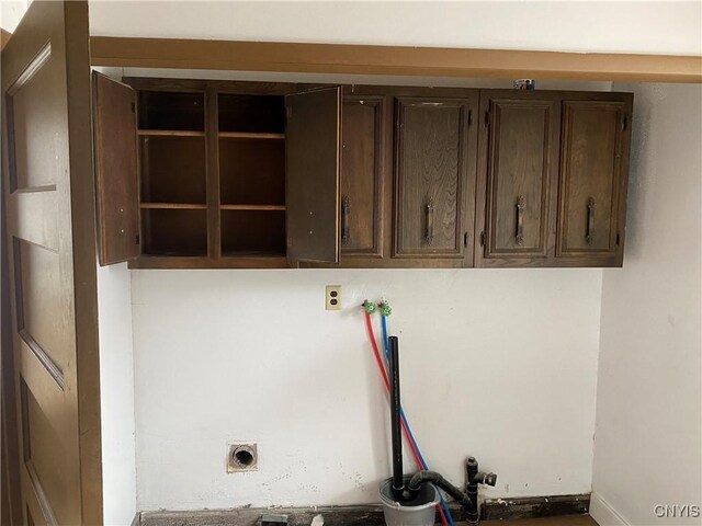 clothes washing area featuring cabinets, electric dryer hookup, and hookup for a washing machine