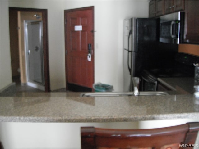 kitchen with black fridge