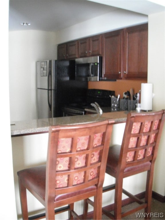 kitchen featuring kitchen peninsula and appliances with stainless steel finishes