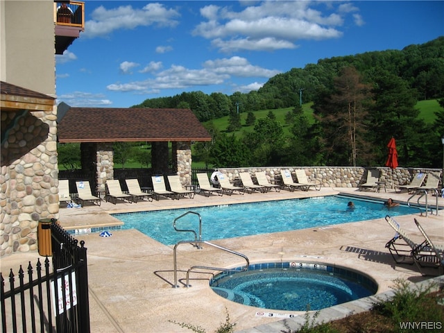 view of pool featuring a patio area and a community hot tub