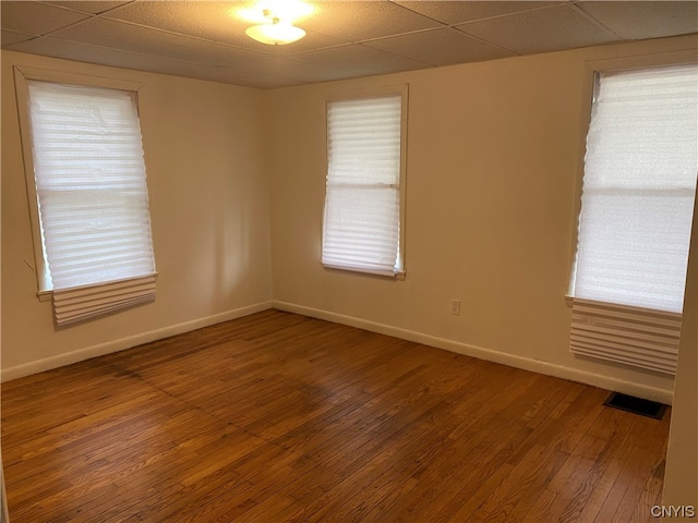 unfurnished room featuring a paneled ceiling and hardwood / wood-style flooring