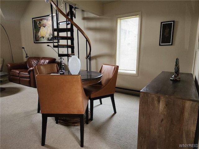 carpeted dining room featuring a baseboard heating unit