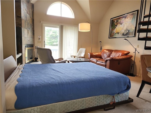 bedroom with a fireplace, light carpet, and high vaulted ceiling