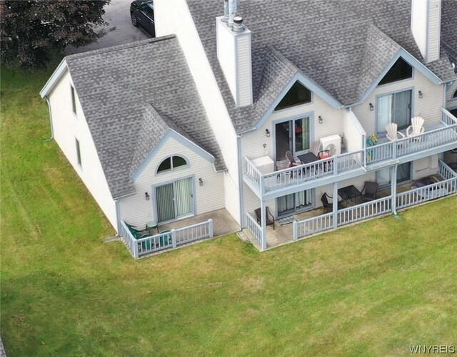 back of house with a lawn and a wooden deck