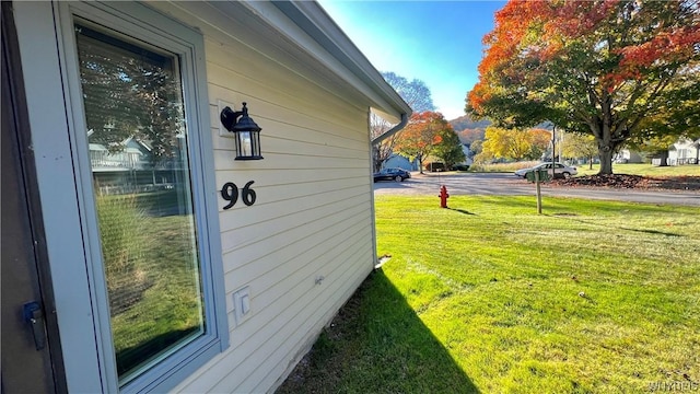 view of side of property with a lawn