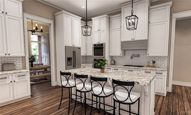 kitchen with hanging light fixtures, appliances with stainless steel finishes, and a breakfast bar