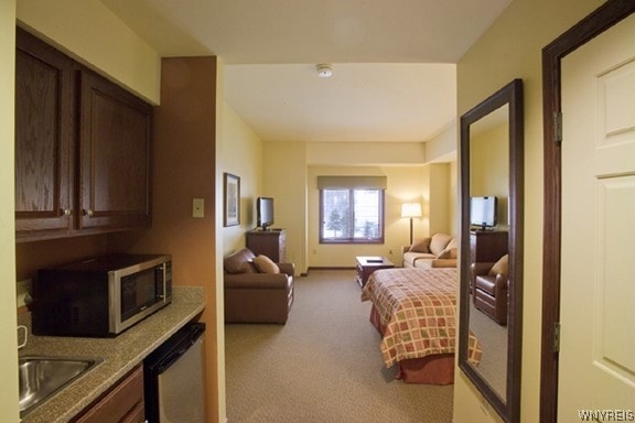 carpeted bedroom with sink