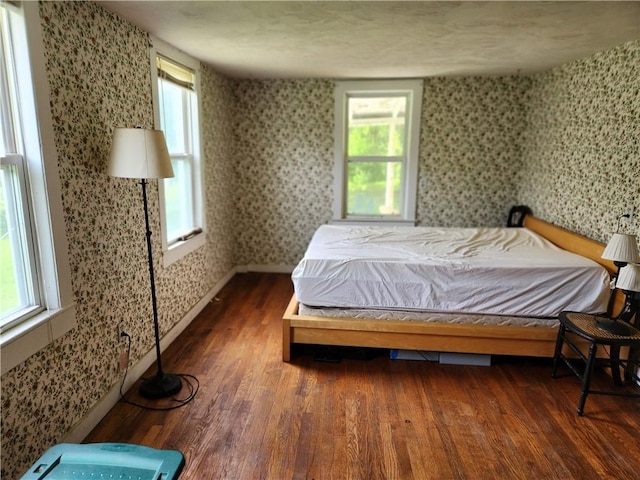 151 Schultz Rd, Sanford, NY 13754 - bedroom featuring wallpapered walls, wood finished floors, and baseboards