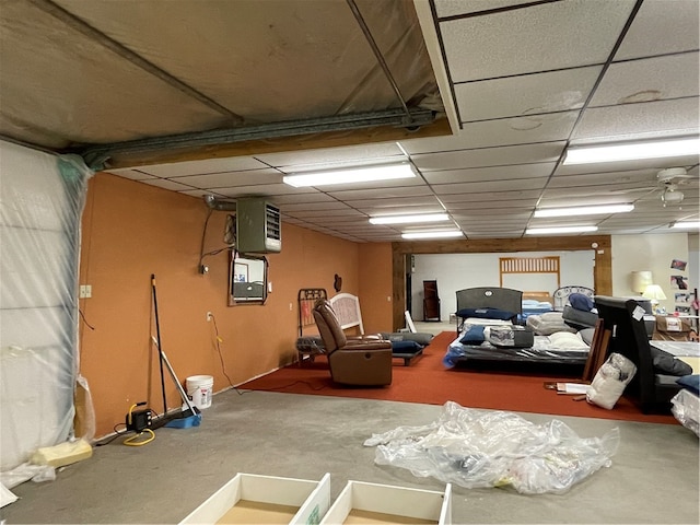 interior space featuring ceiling fan and a drop ceiling