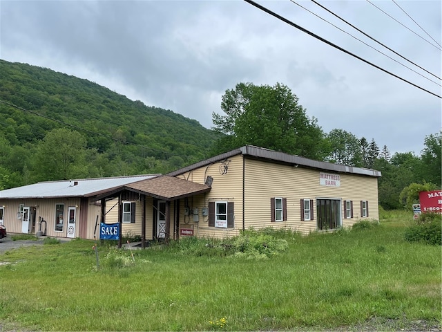 view of front of house featuring a front lawn and a mountain view