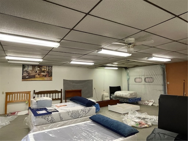 bedroom with ceiling fan and a paneled ceiling