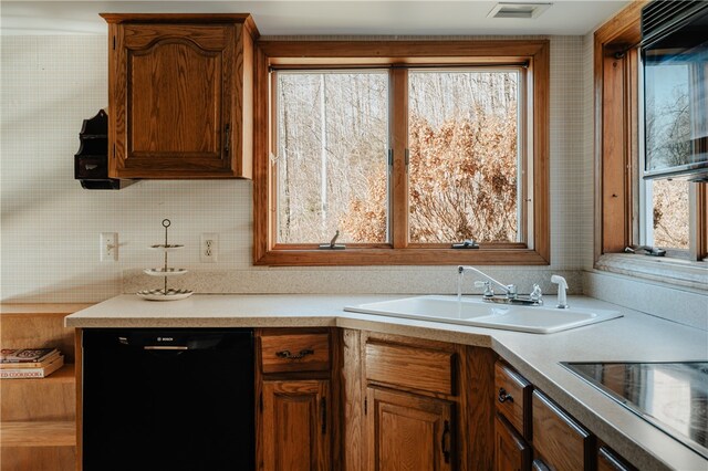 kitchen with backsplash, sink, and black appliances