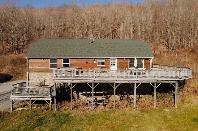 rear view of property with a wooden deck