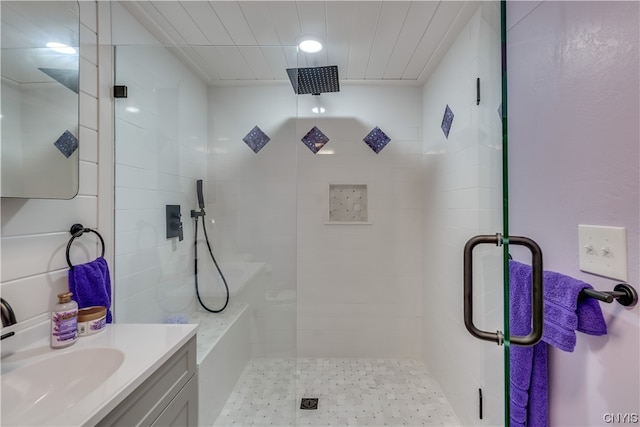 bathroom featuring vanity and a shower with door