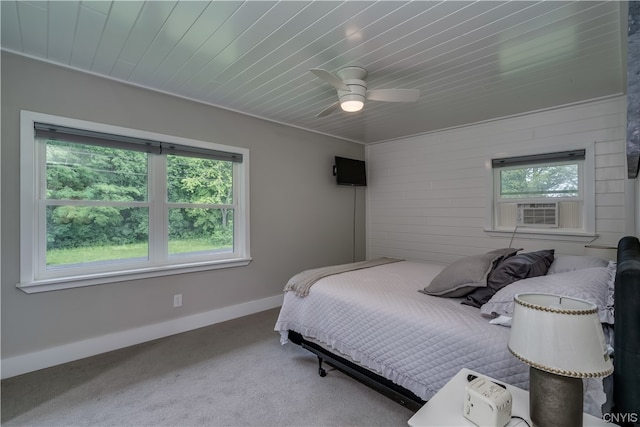 carpeted bedroom featuring ceiling fan and wood ceiling