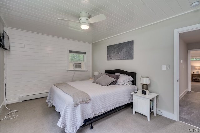 carpeted bedroom with ceiling fan and baseboard heating