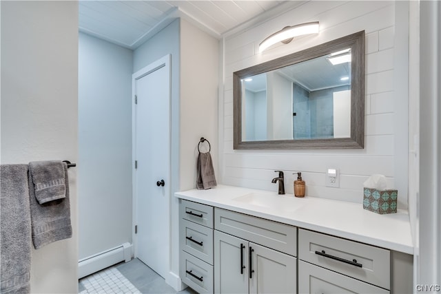 bathroom with tile flooring, a baseboard radiator, and oversized vanity