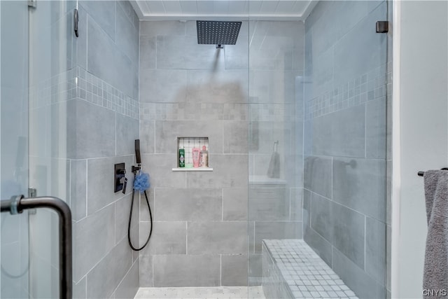 bathroom featuring a shower with shower door