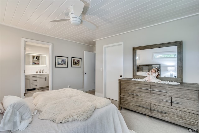 carpeted bedroom with ceiling fan, connected bathroom, and wooden ceiling