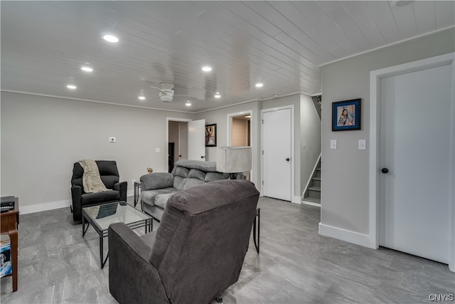 living room featuring light tile floors, ceiling fan, and ornamental molding