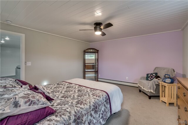 carpeted bedroom featuring ornamental molding, ceiling fan, and baseboard heating