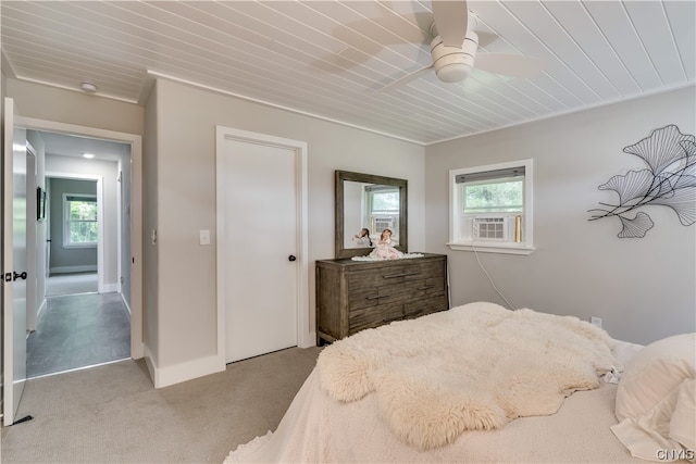 carpeted bedroom with multiple windows, ceiling fan, and wooden ceiling