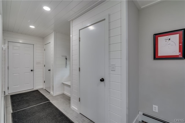 interior space featuring a baseboard heating unit and light tile floors