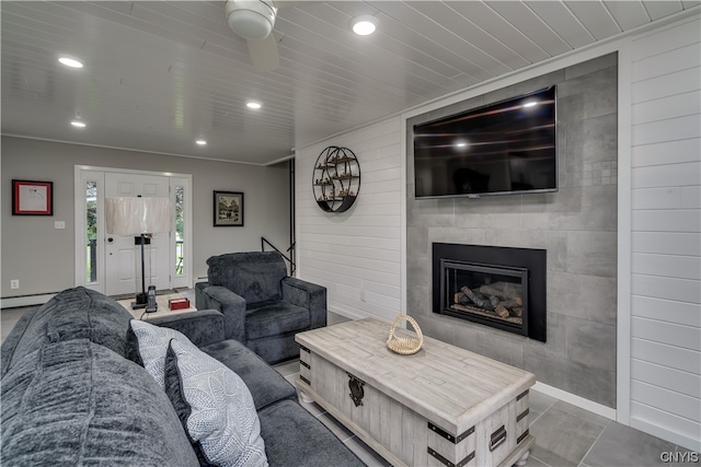 living room with tile walls, tile floors, a fireplace, and a baseboard heating unit