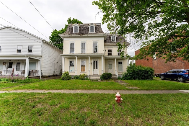 view of front facade with a front lawn and a porch