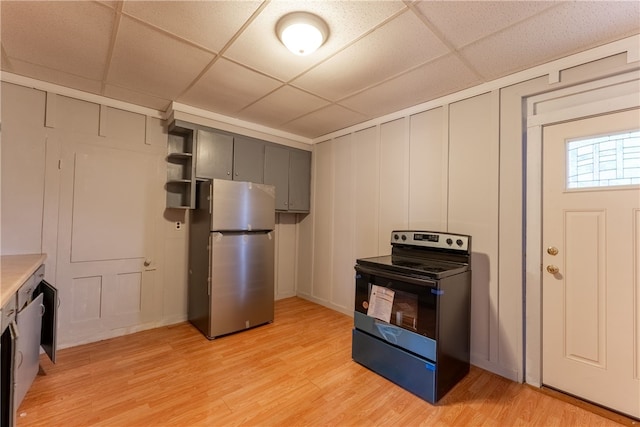 kitchen featuring gray cabinetry, light wood-type flooring, range with electric stovetop, a drop ceiling, and stainless steel refrigerator