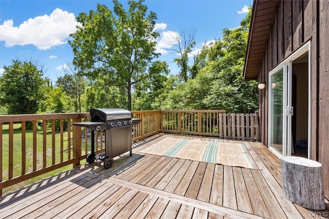 wooden deck featuring a yard and grilling area