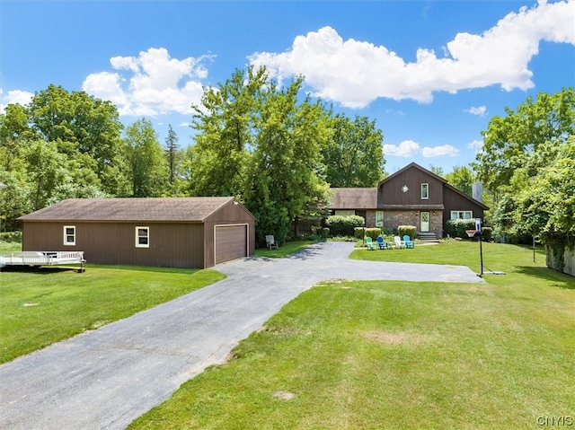 view of front of home featuring an outbuilding, a garage, and a front lawn