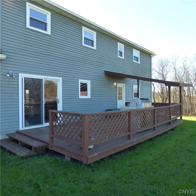 back of house featuring a wooden deck, outdoor lounge area, and a yard