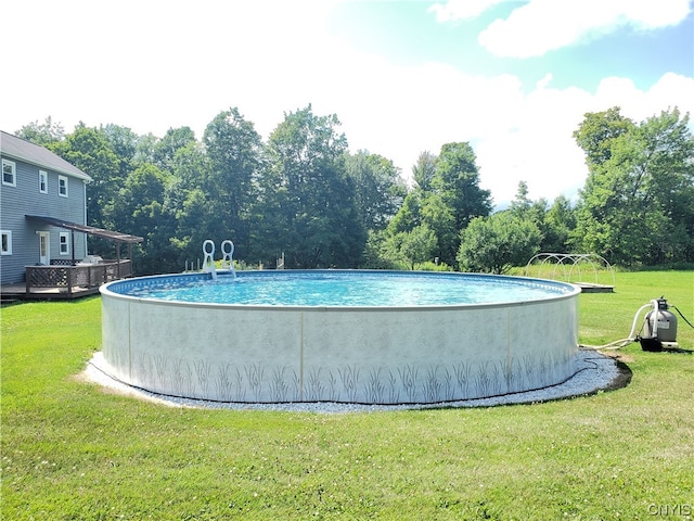 view of pool featuring a yard