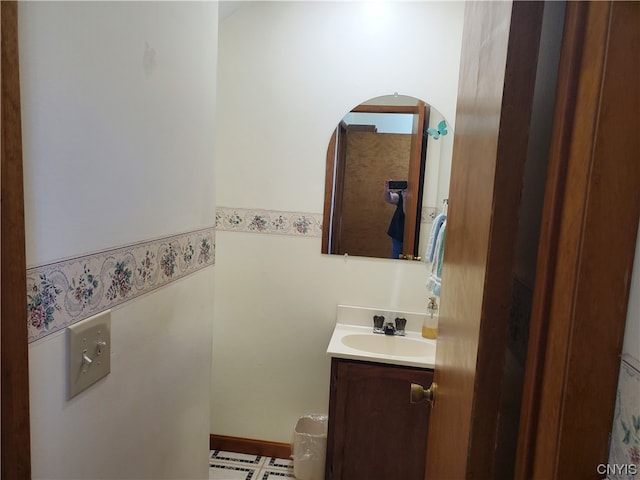 bathroom with tile flooring and vanity