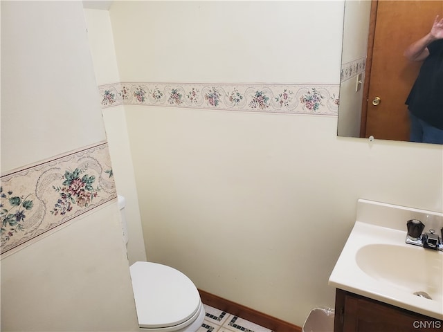 bathroom with vanity, tile floors, and toilet