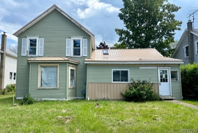 rear view of house with a yard